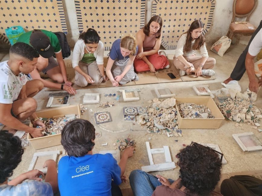 Students sitting and piecing together Moroccan tilework