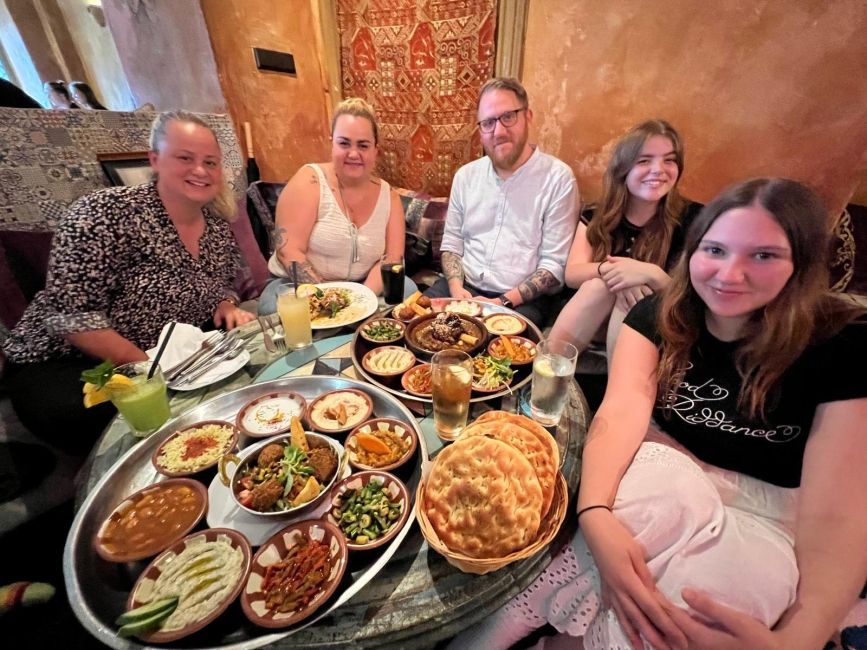 Two students and their host family at a Moroccan restaurant 
