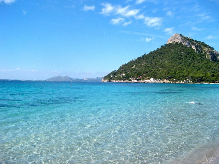 23461_Study Abroad_Palma De Mallorca_Mediterranean Sea_ blue water and vegetative hill in background. Snorkeler in shallows._0.jpg