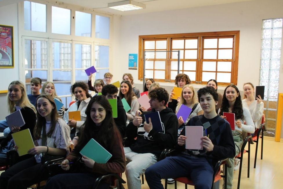 High school semester abroad students sitting in classroom with notebooks