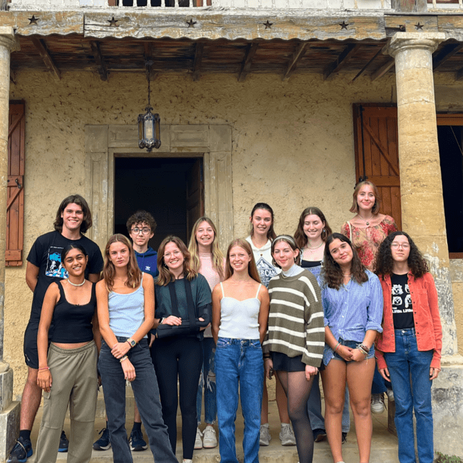 High school students posing beside an alpaca farm in France