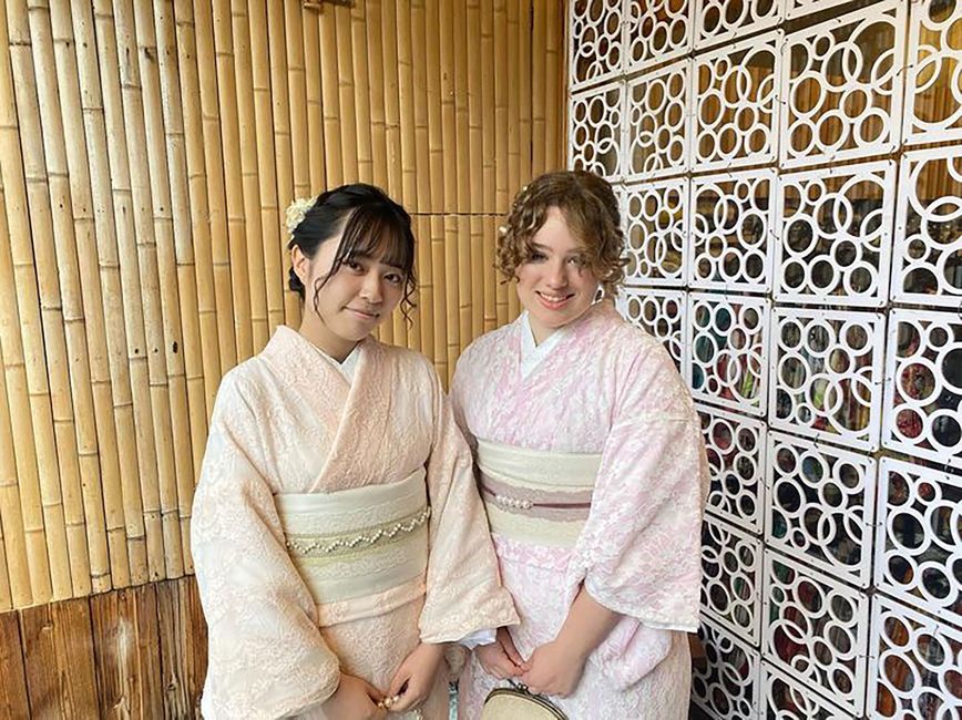 Exchange student and friend in kimonos posing together in Japan