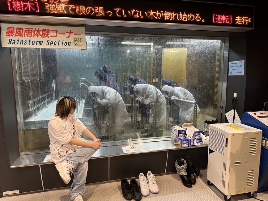 Global Navigators go through the typhoon simulation where they experience the rushing winds and pouring rain of one of nature's fiercest storms.