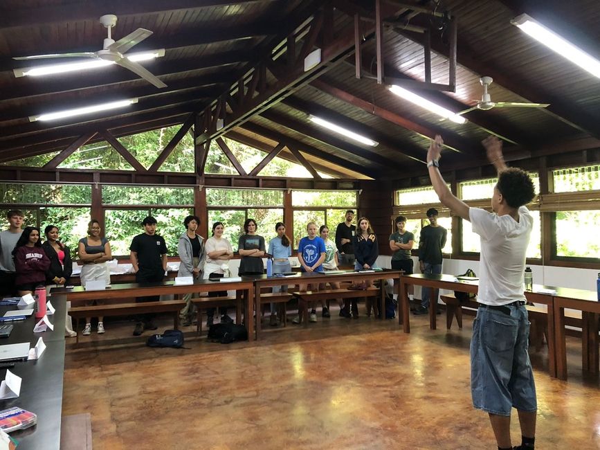 A student leads a review charades game in their Climate Change Mitigation class.