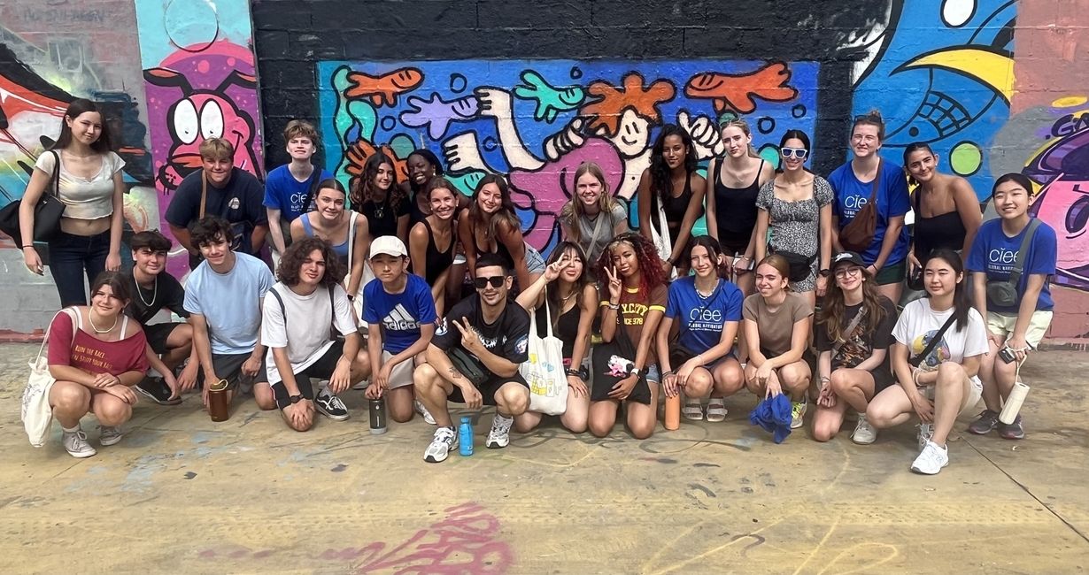 Students with Camil Escruela in front of their mural