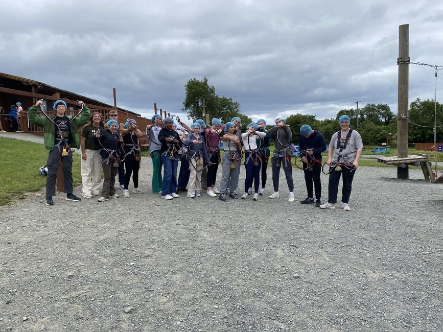 Students pose for a photo before taking on the high ropes course.