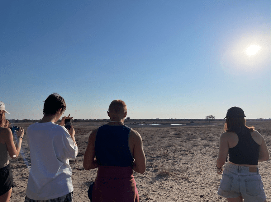 Students observing the rhino and zebras.