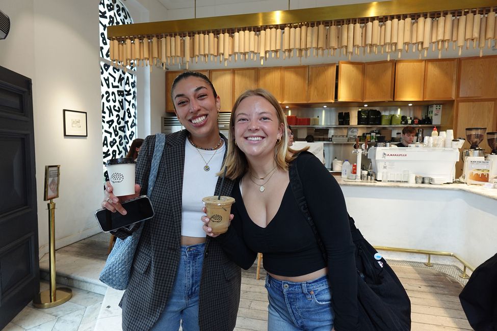 Students holding coffee cups in a café in Sydney