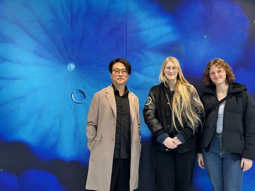 Picture of Artist Nam Sang Woon and students Lauren Harris and Kathatine Shertz in front of Blue Moon Series