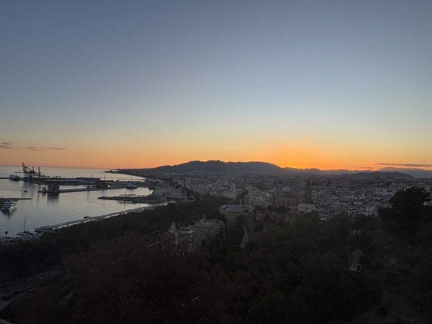 An aerial view of the city and harbor of Málaga, Spain at sunset