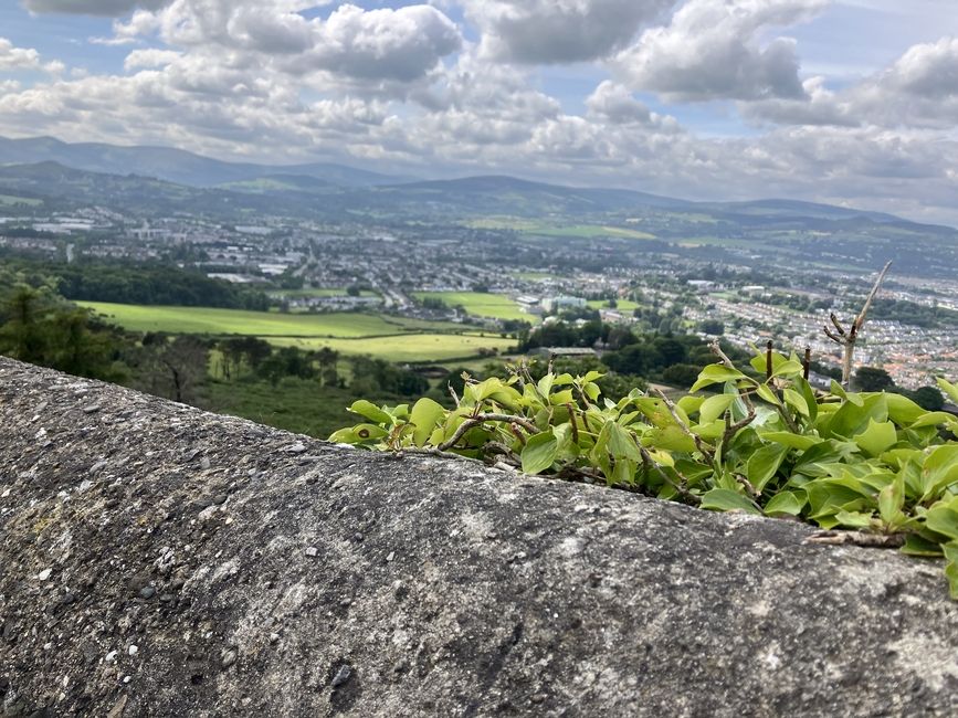 landscape of rolling green fields and town in Ireland