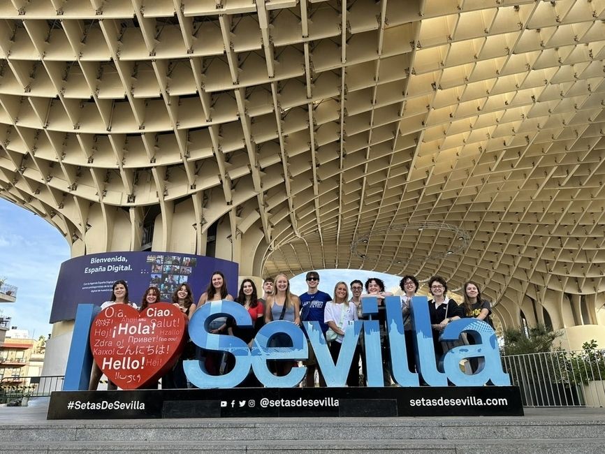 Gap year students posing with Sevilla sign in Spain
