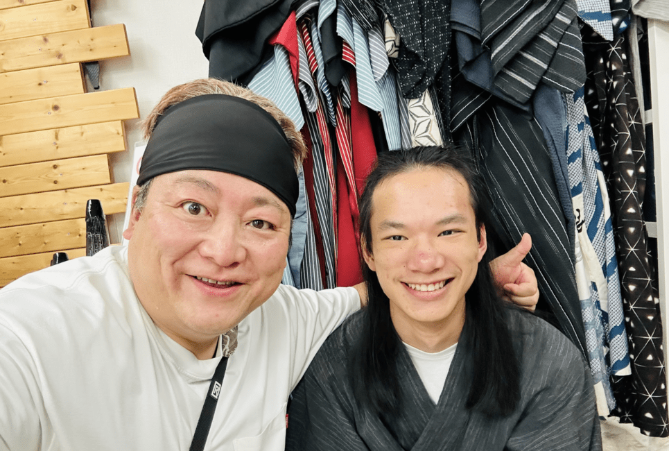 student smiling next to yukata salesman