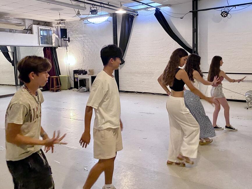 Students taking steps and moving their arms in the same direction