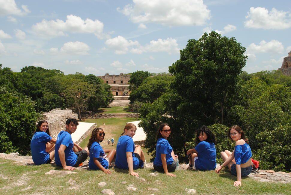 HSSA Students sit on a hill overlooking the ruins of the ancient city of Uxmal