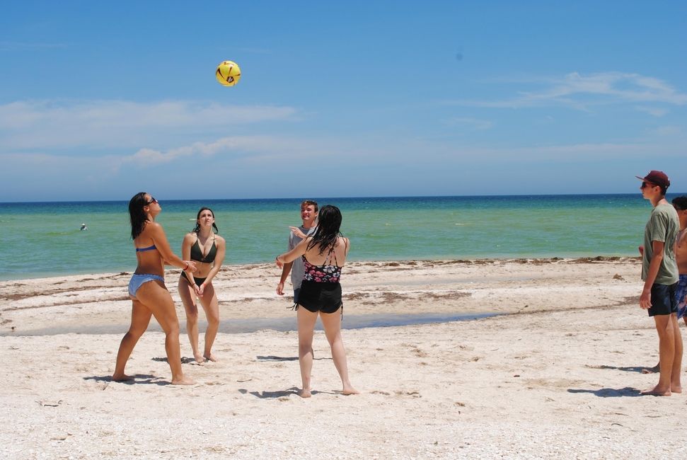 Students playing beach volleyball