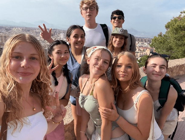 Students smile together on top of the Castillo, an iconic landmark in Alicante.