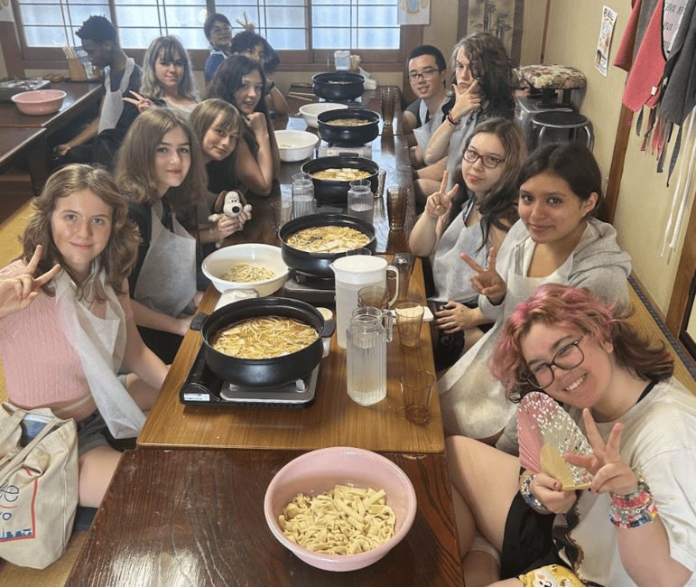 students posing with newly made hoto, a noodles dish