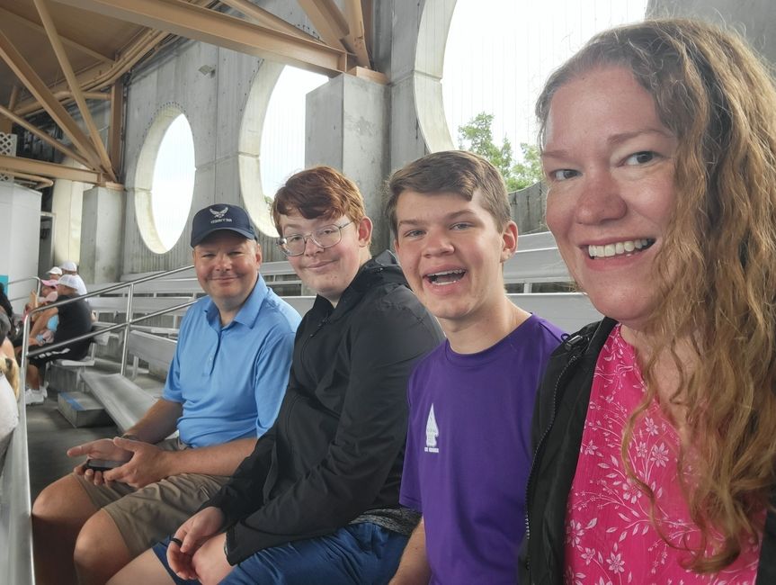 A Smiling Family Sits in a Seaworld Arena