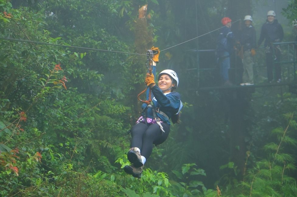 Women for Environmental Action student, Karina, ziplining across the cloud forest and smiling
