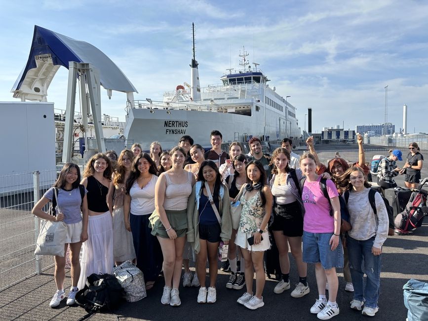 Students stand in front of ferry before boarding 