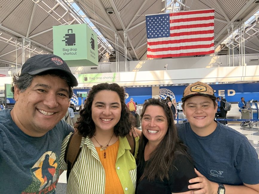 Emiko's family at the airport under an American flag