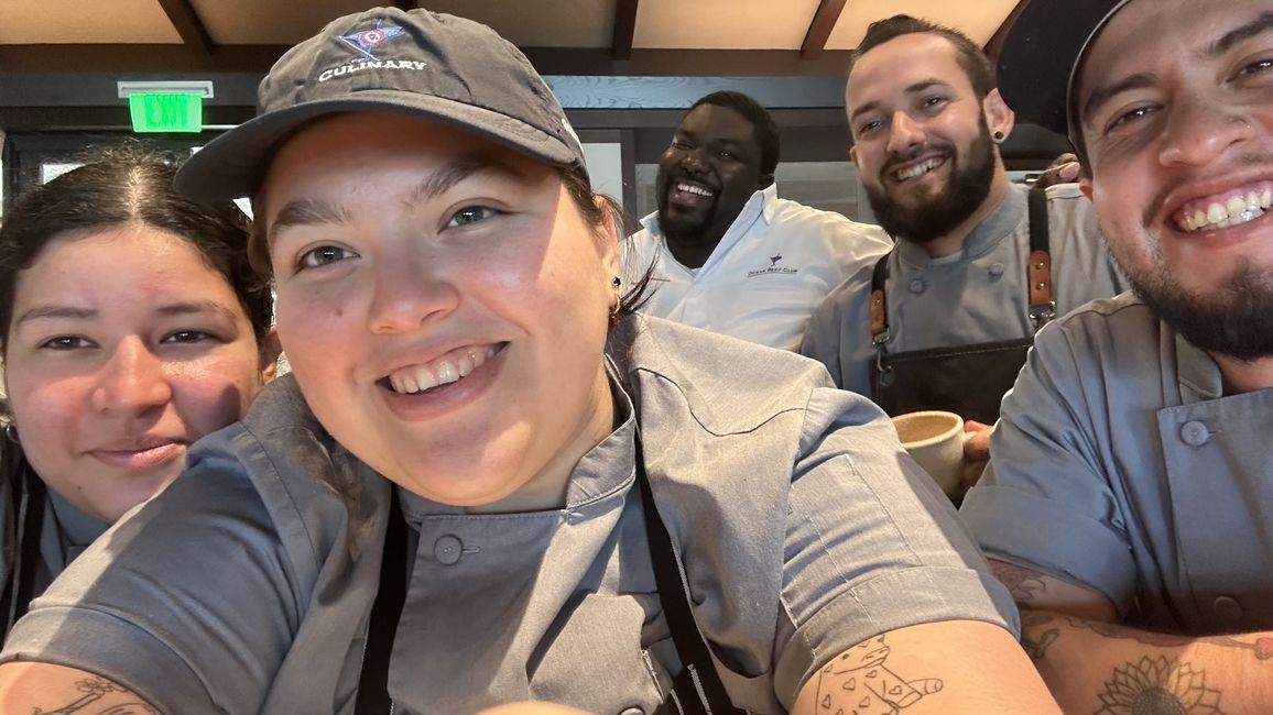 Maria poses with her friends in the Ocean Reef Club kitchen.