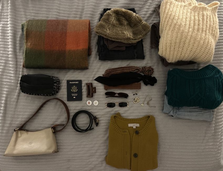 Clothes spread out on a bed