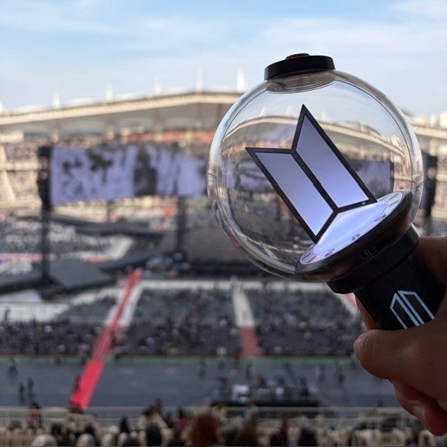 BTS concert stage with ARMY lightstick in front of it