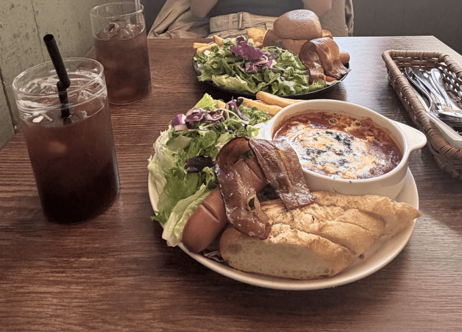 Two brunch meals with salad and bread, including drinks.