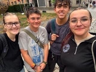 Hannah W. (left) stands with new friends
