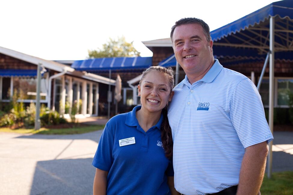 An employer, right, stands with one of his BridgeUSA Summer Work Travel participants.