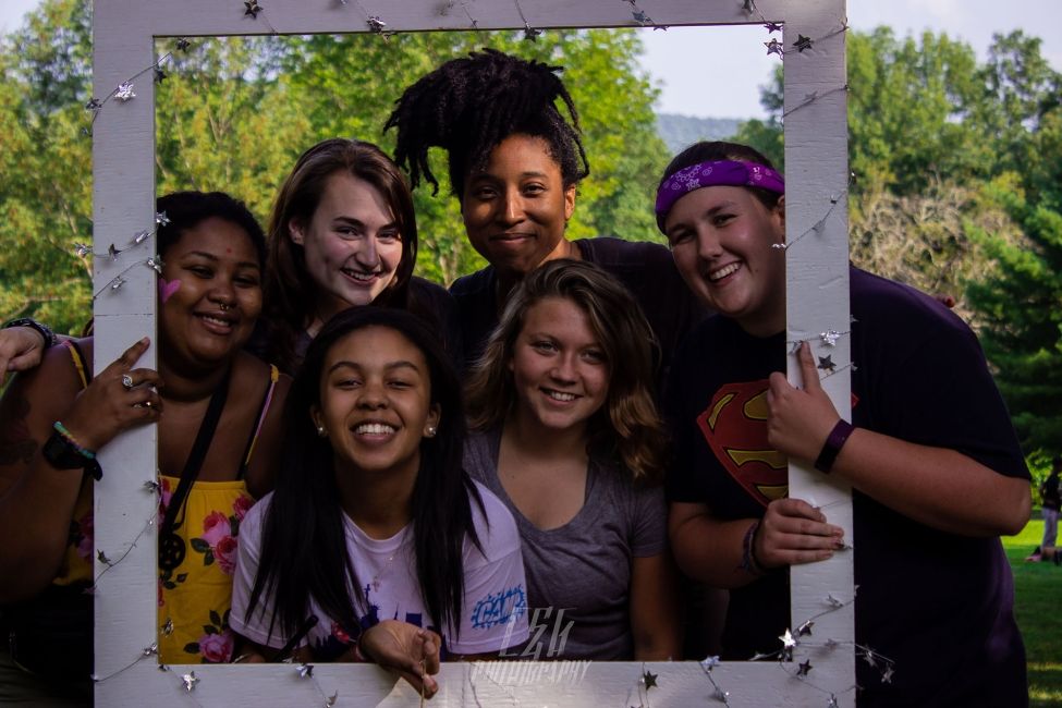 Campers taking photo in giant picture frame