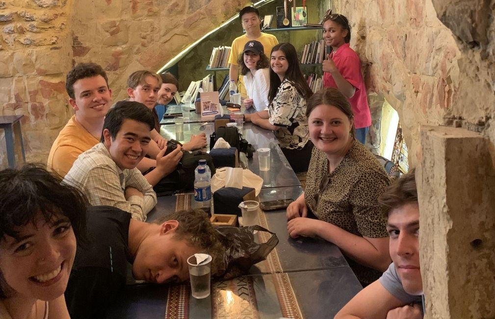 amman students eating meal in cave