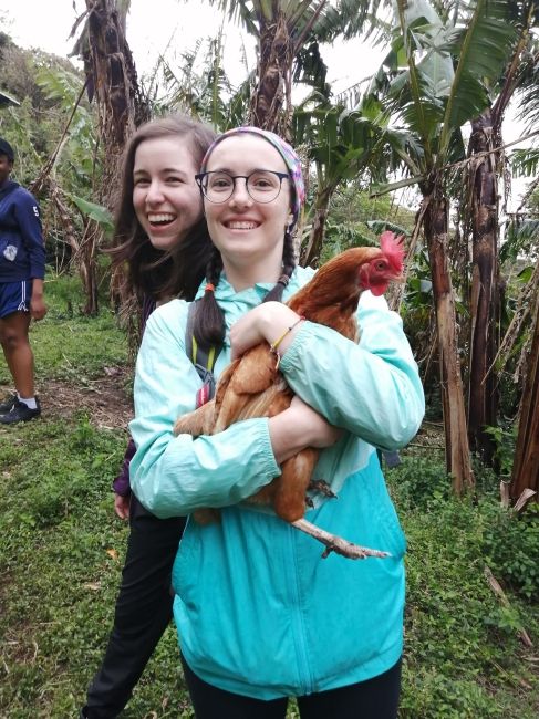 Student holding a chicken in Monteverde