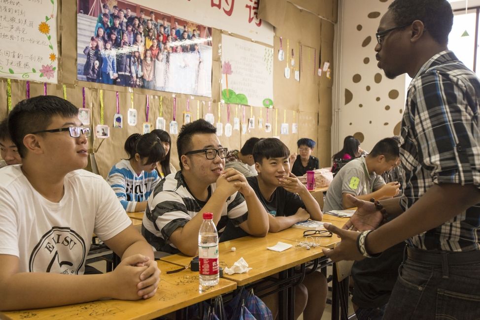 Teach in China teacher with his students in classroom