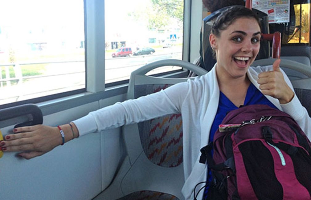 student with backpack on alcala spain bus