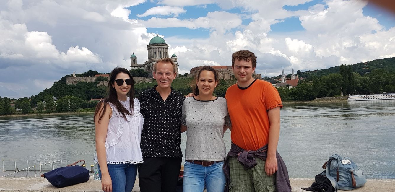 Group of men and women smiling by the water in Budapest