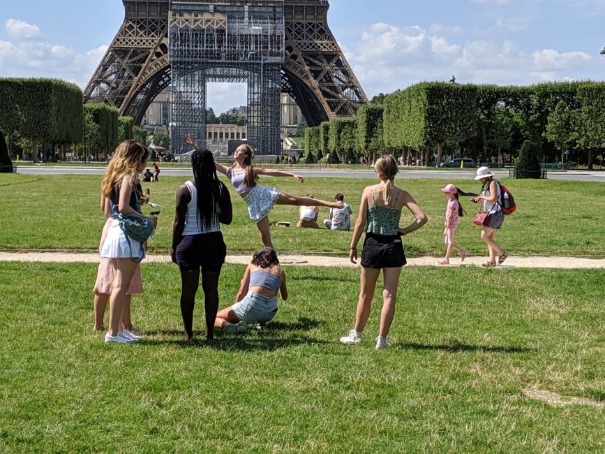 High school students frolicking by the Eiffel Tower
