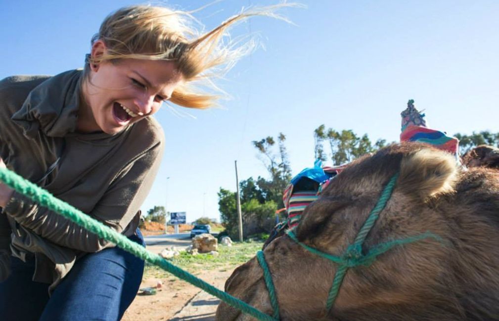 smiling at camel during study abroad