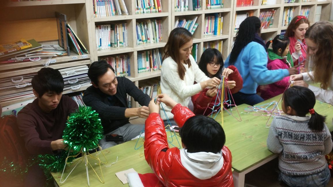Teachers and students doing a craft in class
