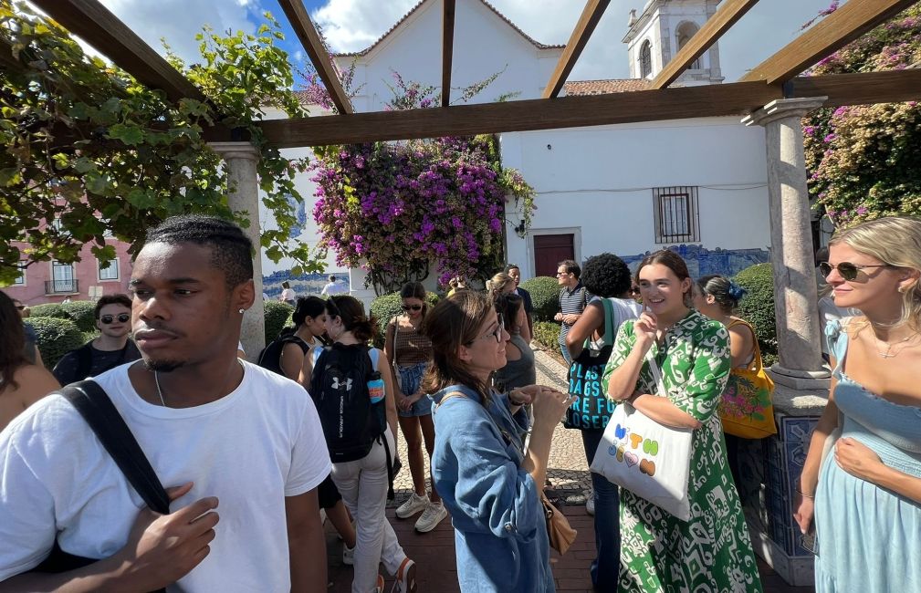 students mingle by lisbon city overlook sunny day