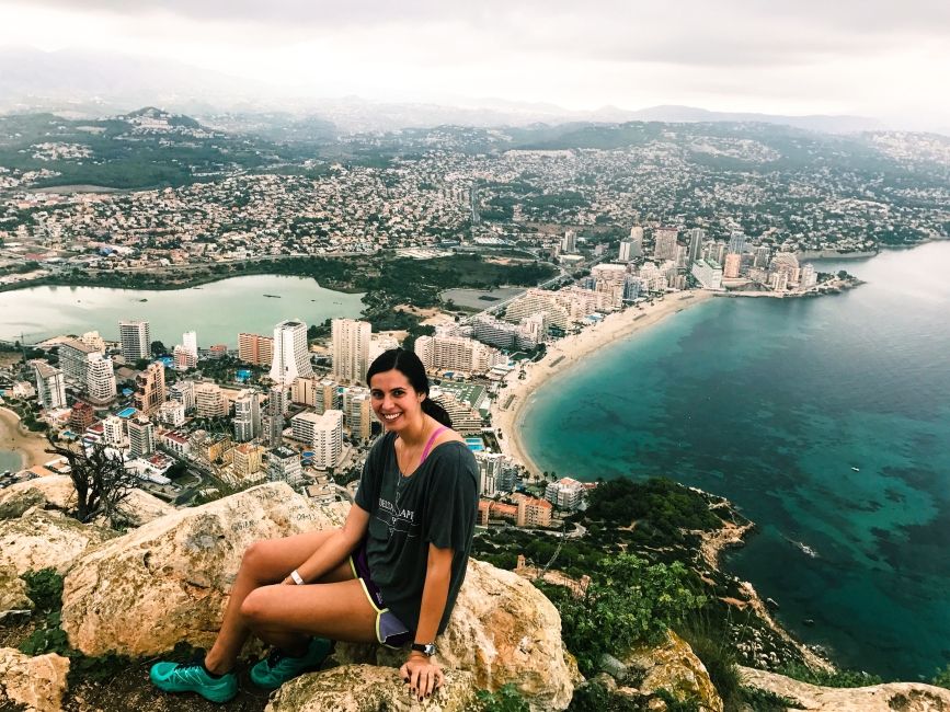 alicante girl on cliff above city