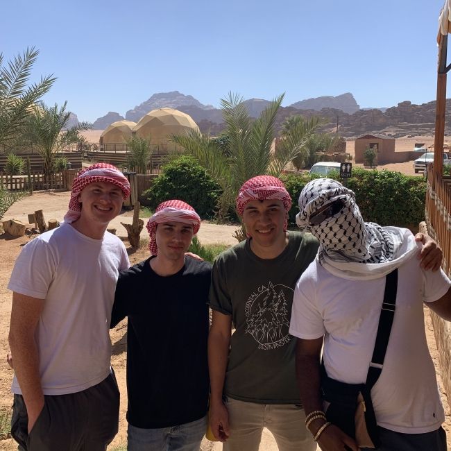 amman students smiling together desert
