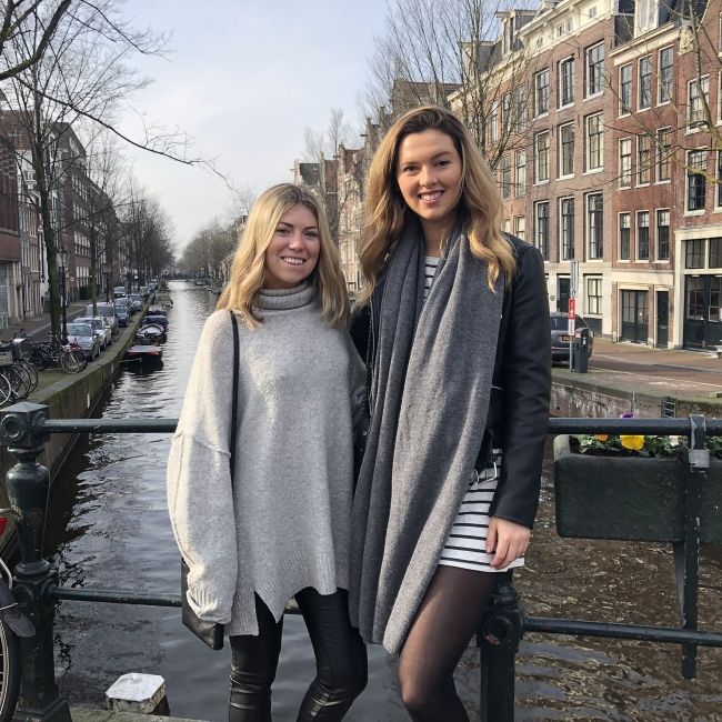 amsterdam two students smiling bridge