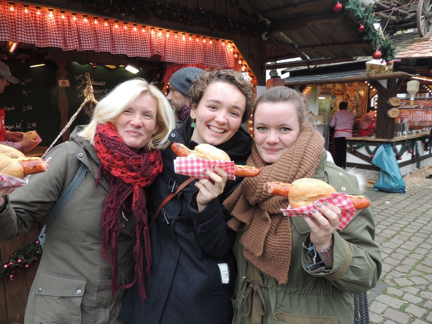 High school abroad students holding up sausages in Berlin