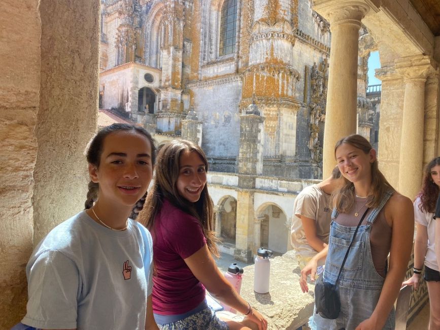 Group of high school students posing by columns in a Lisbon castle