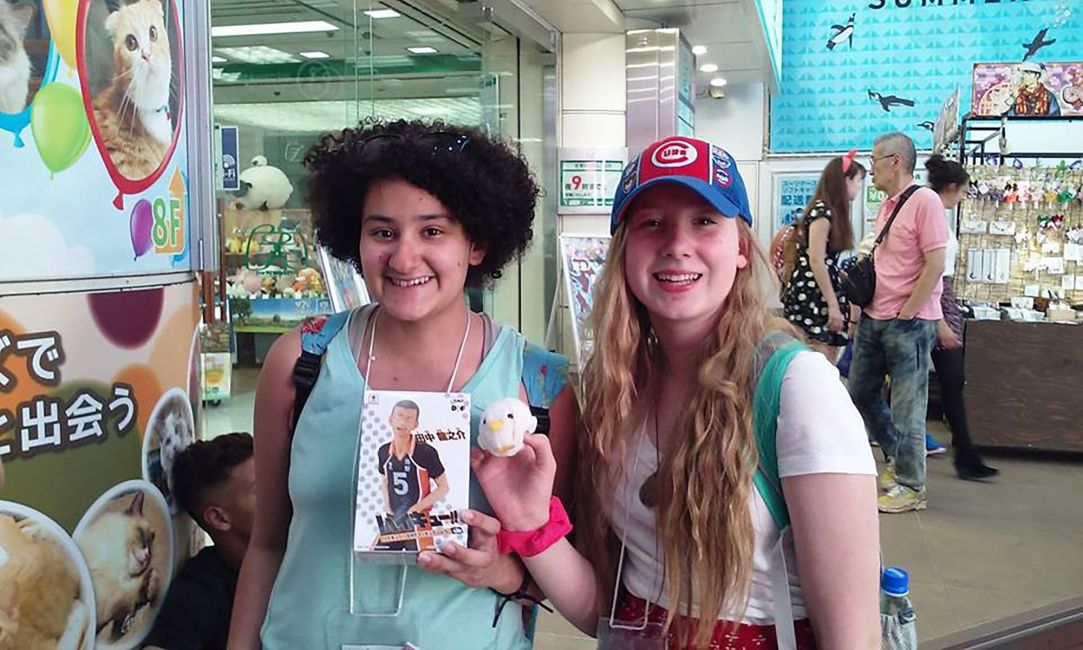 Students holding up items in store in Tokyo