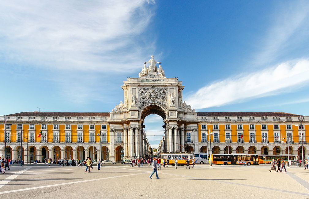 lisbon plaza with archway and yellow building