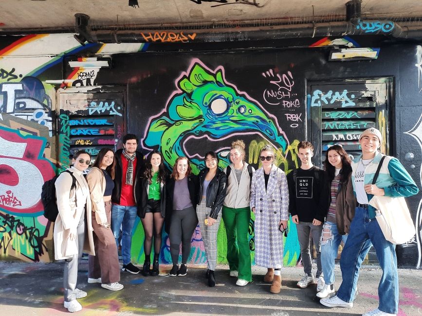london student group at graffiti wall